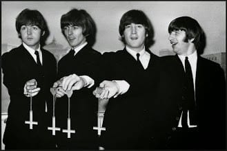 The Beatles holding upside down crosses