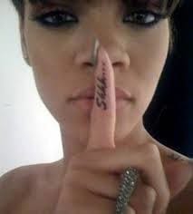 Rihanna showing Illuminati gesture